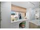 Bright dressing room with vanity, built-in cabinetry, and window at 50 Coe Rd # 331, Belleair, FL 33756