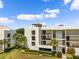 Condo building exterior with lush landscaping and golf course views at 50 Coe Rd # 331, Belleair, FL 33756