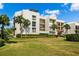 Modern condo building with lush landscaping and ample parking at 50 Coe Rd # 331, Belleair, FL 33756