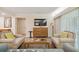 Living area with two armchairs, a sofa, and a wood cabinet with TV at 36750 Us Highway 19 N # 20-213, Palm Harbor, FL 34684