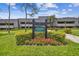 Exterior view of Prestwick Lodge 20, showing landscaping and signage at 36750 Us Highway 19 N # 20-213, Palm Harbor, FL 34684