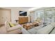 Living room with comfy seating, a coffee table, and a large TV at 36750 Us Highway 19 N # 20-213, Palm Harbor, FL 34684