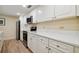 Modern kitchen with white cabinets and stainless steel appliances at 36750 Us Highway 19 N # 20-213, Palm Harbor, FL 34684