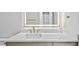 Close-up of a modern bathroom vanity with a large mirror and white countertop at 2519 N Riverside Dr, Tampa, FL 33602