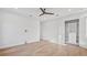 Bright bedroom featuring hardwood floors, a ceiling fan, and a closet with built-in shelving at 2519 N Riverside Dr, Tampa, FL 33602