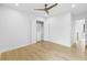 Bright bedroom with a modern ceiling fan and custom closet, featuring hardwood floors and white walls at 2519 N Riverside Dr, Tampa, FL 33602