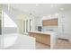 Modern kitchen with white cabinetry, quartz countertops, wood accents, and stainless steel appliances at 2519 N Riverside Dr, Tampa, FL 33602