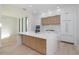 Modern kitchen with white cabinetry, quartz countertops, wood accents, stainless steel appliances, and wood floors at 2519 N Riverside Dr, Tampa, FL 33602