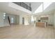 Bright open-concept living room with high ceilings, modern lighting, wood floors, and seamless kitchen access at 2519 N Riverside Dr, Tampa, FL 33602