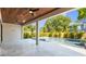 Covered outdoor patio with travertine tile, ceiling fans, columns, and view to the pool area at 2519 N Riverside Dr, Tampa, FL 33602