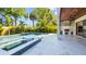 Outdoor pool area featuring a spa, travertine deck, an outdoor kitchen, and a wooden ceiling at 2519 N Riverside Dr, Tampa, FL 33602