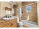 Updated bathroom with tiled shower and tub, vanity, and neutral color scheme at 7725 Still Lakes Dr, Odessa, FL 33556