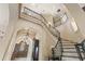 Impressive curved staircase with ornate iron railings at 7725 Still Lakes Dr, Odessa, FL 33556