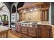 High-end kitchen features a Wolf range, custom cabinetry, and a stylish backsplash at 7725 Still Lakes Dr, Odessa, FL 33556