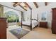 Bright bedroom with a large window, post bed, and wood dresser at 7725 Still Lakes Dr, Odessa, FL 33556