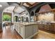 Spacious kitchen with large island, granite countertops, and access to outdoor area at 7725 Still Lakes Dr, Odessa, FL 33556
