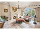 Bright sitting room with fireplace, large windows and comfortable seating at 7725 Still Lakes Dr, Odessa, FL 33556