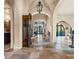 Elegant entryway with high ceilings, arched doorways and antique clock at 7725 Still Lakes Dr, Odessa, FL 33556