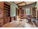 Home office with built-in bookshelves and leather armchairs at 7725 Still Lakes Dr, Odessa, FL 33556