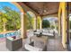 Relaxing covered patio overlooking the pool and lush landscaping at 7725 Still Lakes Dr, Odessa, FL 33556