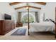 Spacious bedroom with a large arched window and a four-poster bed at 7725 Still Lakes Dr, Odessa, FL 33556