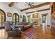 Relaxing Gathering room featuring a fireplace, leather seating, and hardwood floors at 7725 Still Lakes Dr, Odessa, FL 33556