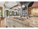 Island kitchen features a double sink, granite countertops, and high-end faucet at 7725 Still Lakes Dr, Odessa, FL 33556
