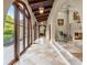 Elegant hallway with arched doorways, tiled floors, and access to outdoor patio at 7725 Still Lakes Dr, Odessa, FL 33556