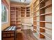 Spacious library featuring built-in bookshelves and a writing desk at 7725 Still Lakes Dr, Odessa, FL 33556