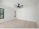 Spacious bedroom featuring hardwood floors, ceiling fan, and large windows at 2519 N Riverside Dr, Tampa, FL 33602