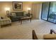 Living room with sofa and balcony access at 36750 Us Highway 19 N # 15-310, Palm Harbor, FL 34684