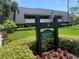 Building exterior, Muirfield Lodge 15, with landscaping at 36750 Us Highway 19 N # 15-310, Palm Harbor, FL 34684
