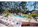 Smaller pool with waterfall feature and lounge chairs at 36750 Us Highway 19 N # 15-310, Palm Harbor, FL 34684