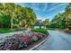 Gated entrance to community with guard house and landscaping at 36750 Us Highway 19 N # 15-310, Palm Harbor, FL 34684