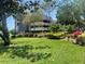 Exterior view of building with landscaping and a grassy area at 36750 Us Highway 19 N # 15-310, Palm Harbor, FL 34684