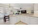 Bright kitchen with white cabinets, granite counters, and breakfast bar at 6319 Vista Verde E Dr, Gulfport, FL 33707