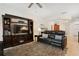 Relaxing living room with a black leather couch and built-in shelving at 6319 Vista Verde E Dr, Gulfport, FL 33707