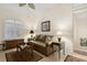 Cozy living room with leather sofa and large window with plantation shutters at 6319 Vista Verde E Dr, Gulfport, FL 33707