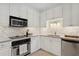 Modern kitchen with white shaker cabinets and stainless steel appliances at 6319 Vista Verde E Dr, Gulfport, FL 33707
