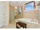 Spa-like bathroom with soaking tub, shower, and updated fixtures at 6319 Vista Verde E Dr, Gulfport, FL 33707