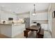 Modern white kitchen with breakfast bar, stainless steel appliances, and ample cabinet space at 6319 Vista Verde E Dr, Gulfport, FL 33707