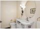 Elegant half bathroom with pedestal sink and oval mirror at 6319 Vista Verde E Dr, Gulfport, FL 33707