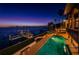 Stunning night view of the property, pool, and private dock at 806 Columbus Dr, Tierra Verde, FL 33715