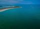 Stunning aerial view of the waterfront featuring crystal-clear turquoise water and sandy shorelines at 806 Columbus Dr, Tierra Verde, FL 33715