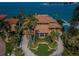 Breathtaking waterfront home with a tile roof, circular driveway, and lush landscaping with ocean views at 806 Columbus Dr, Tierra Verde, FL 33715