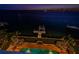 Night view of waterfront property with private dock and pool at 806 Columbus Dr, Tierra Verde, FL 33715