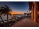 Backyard overlooking the ocean, featuring boat dock, landscaping and unobstructed sunset views at 806 Columbus Dr, Tierra Verde, FL 33715