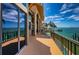 Waterfront balcony with patio, sliding glass doors and tranquil ocean views at 806 Columbus Dr, Tierra Verde, FL 33715