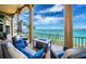Covered balcony offers a relaxing space with ocean views and comfortable seating arrangements at 806 Columbus Dr, Tierra Verde, FL 33715