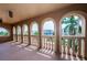 Covered balcony with arched openings offering water views at 806 Columbus Dr, Tierra Verde, FL 33715